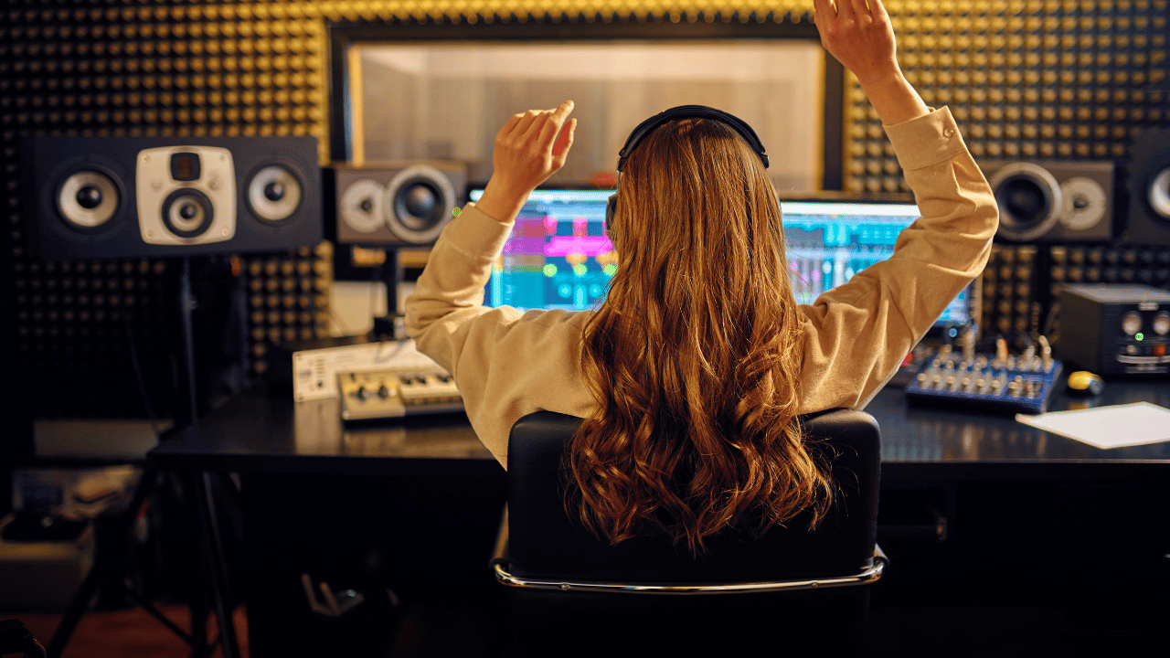 A female music producer is loving the sound of her mix.