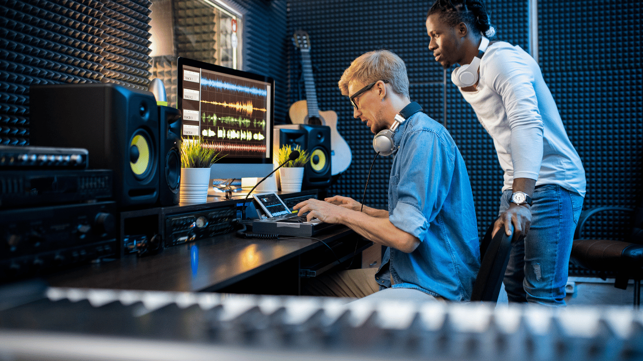 Music producers editing vocals with a DAW in a recording studio 