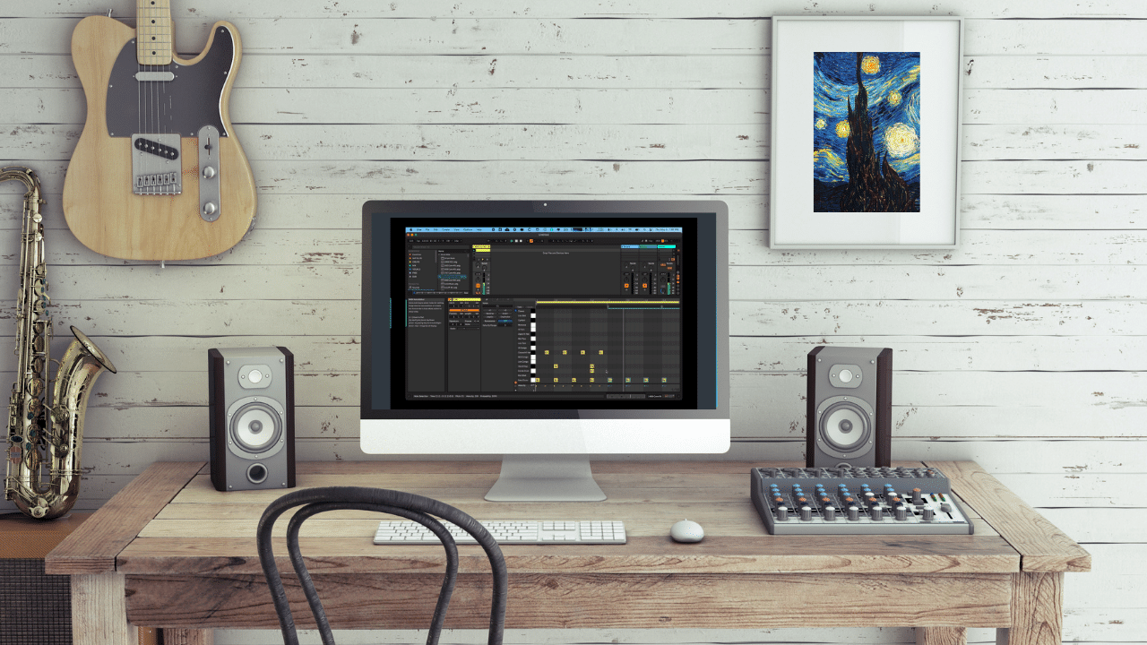 A Digital Audio Workstation on a desk surrounded by musical instruments and audio gear.